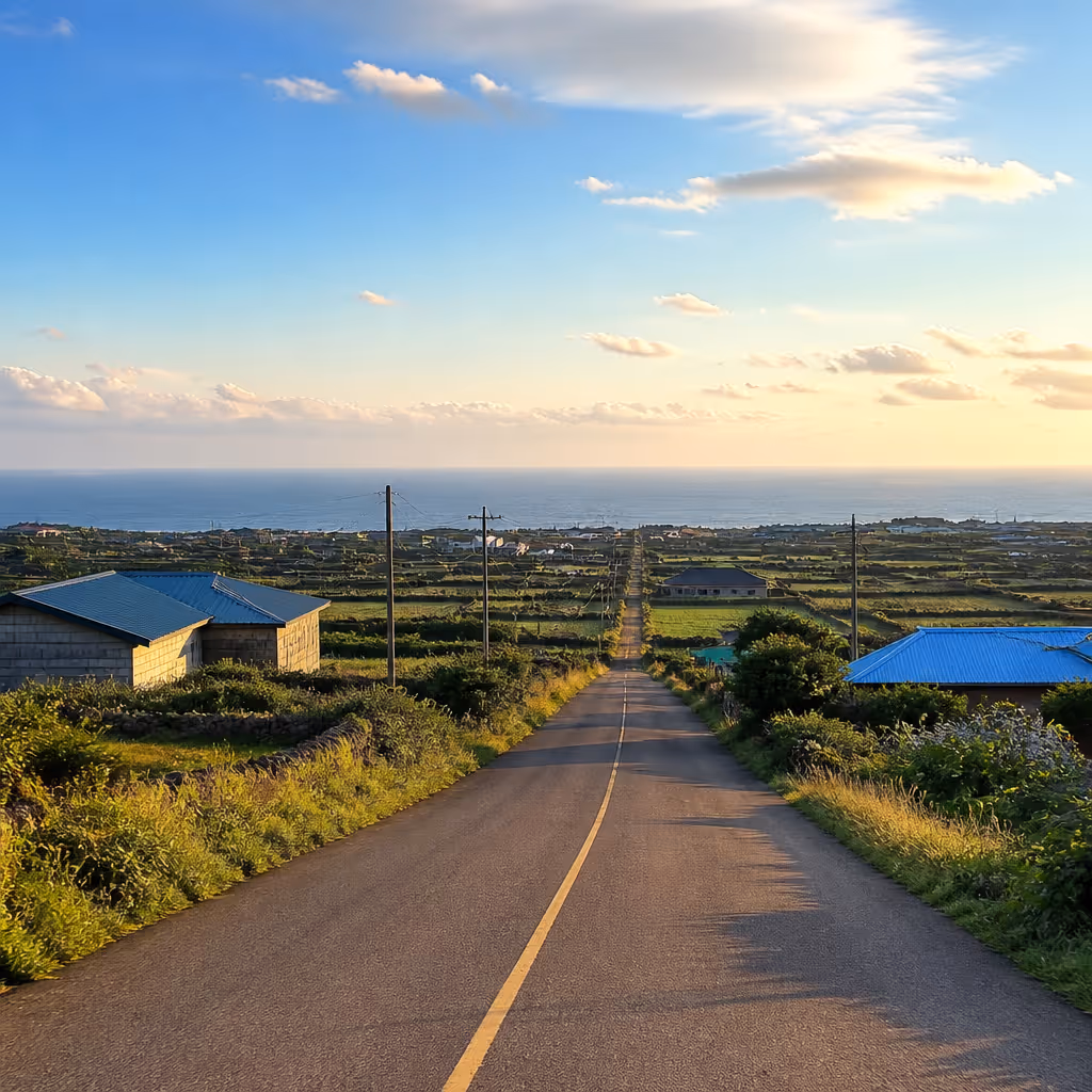 Route from Geumak-ri toward the Aewol coast under afternoon western light along low mid-slope roads